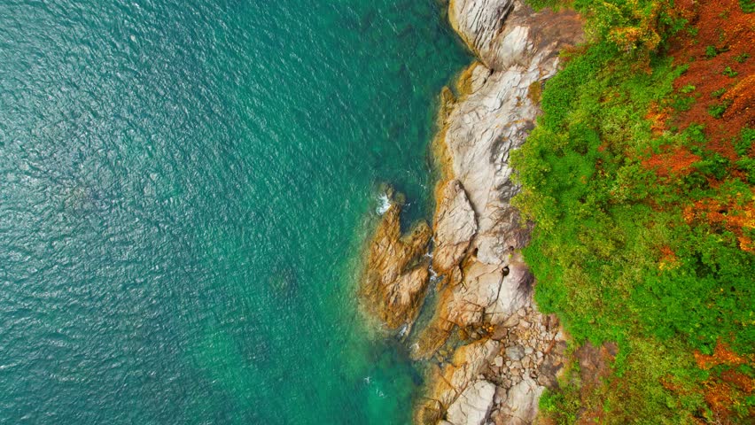 Stunning scenery over beautiful turquoise water and rocky coastline, Ocean waves crashing against the shore. Phuket, Thailand. Most Beautiful tropical sea in asia. summer tropical island. 4K Footage
