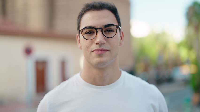 Young hispanic man smiling confident wearing glasses at street | Shutterstock HD Video #1098767925