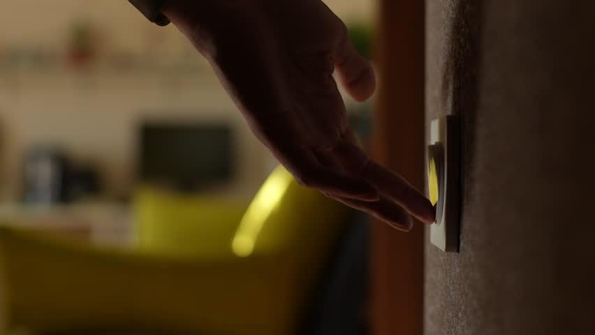 Close up side cropped shot of unrecognizable male turning light on and off by pushing household switch on wall in dark bathroom, view of bright room. Concept of home comfort. Shooting in slow motion. | Shutterstock HD Video #1098770661
