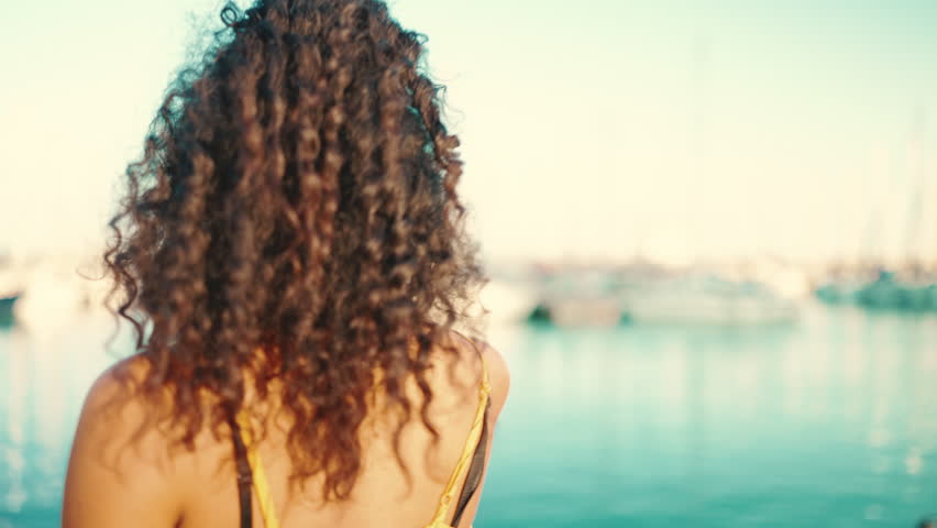 Close-up of young happy man and woman joyful dancing on the embankment on yacht background. Closeup, joyful date of a young interracial couple. Camera moves around people | Shutterstock HD Video #1098770733