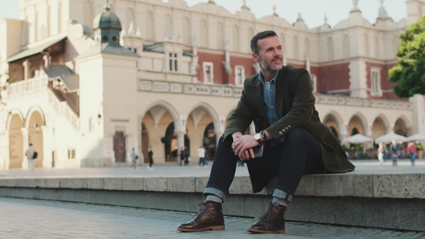 Man sits on the square of the old city