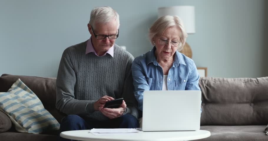 Older 70s spouses calculate bills and expenses feeling stressed due to high electricity prices, huge domicile rates, bank debt, unpaid taxes, lack of money to pay utilities. Small pension, bankruptcy Royalty-Free Stock Footage #1098773587
