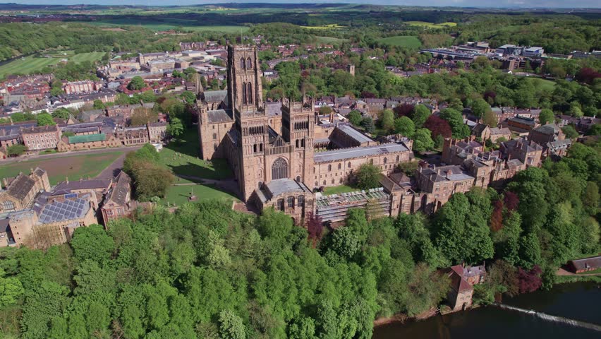 High drone shot flying right above Durham Cathedral on a sunny day, County Durham, UK