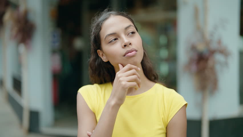 Young african american woman standing with doubt expression at street | Shutterstock HD Video #1098778973