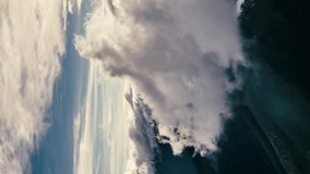 Fluffy clouds rolling over mountains in sunny nature Background Time lapse