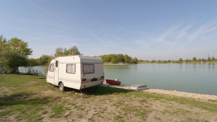 Showing around a tiny travel trailer parking at a lake