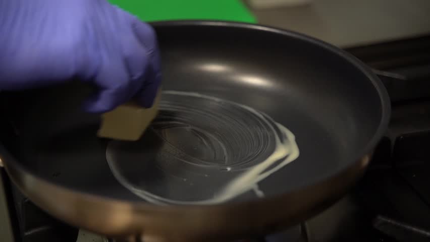 close up slow motion melted butter in a frying pan