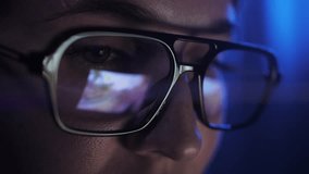 Gamer girl playing an online first person shooter on personal computer. Close up of reflection in glasses on neon lights. - Powered by Shutterstock - Get 15% off with code: PIKWIZARD15