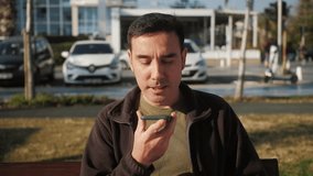 Arab millennial businessman talk on speakerphone with friend makes voice recognition use virtual assistant digital application record audio message on mobile app. - Powered by Shutterstock - Get 15% off with code: PIKWIZARD15