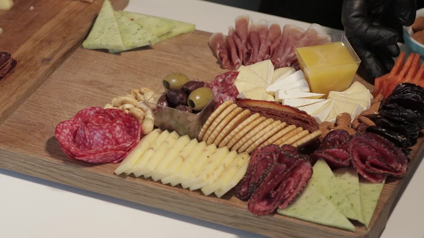 Appetizers boards with assorted cheese, meat, grape and nuts. Charcuterie and cheese platter. Speed Motion
