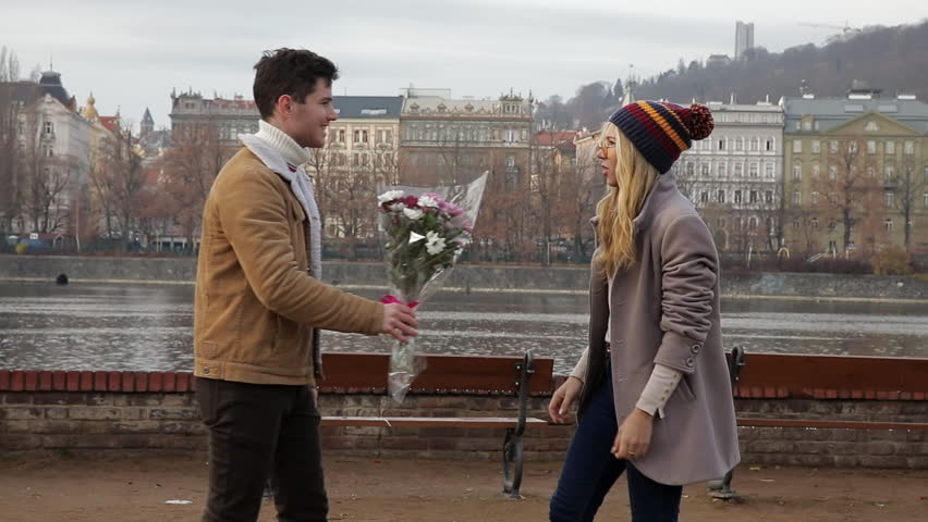 Young man gives a girl flowers and she beats him with a bouquet for treason. Young couple screaming and quarreling on date. Unsuccessful date on Valentine's Day, International Women's Day, March 8 Royalty-Free Stock Footage #1098788715