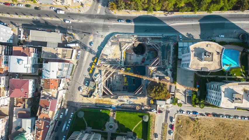4K hyperlapse time-lapse of under construction site, crane, and car traffic transportation in city downtown. Drone aerial top view. Industrial business or civil engineering technology concept Royalty-Free Stock Footage #1098790525