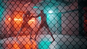 MMA fighters enter the cage ring. Mixed martial arts fight. Cinematic staged fight. Boxing in a ring or cage. Two fighters fight for the right to be the champion. - Powered by Shutterstock - Get 15% off with code: PIKWIZARD15