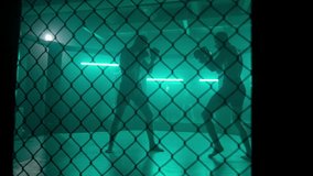 MMA fighters enter the cage ring. Mixed martial arts fight. Cinematic staged fight. Boxing in a ring or cage. Two fighters fight for the right to be the champion. - Powered by Shutterstock - Get 15% off with code: PIKWIZARD15