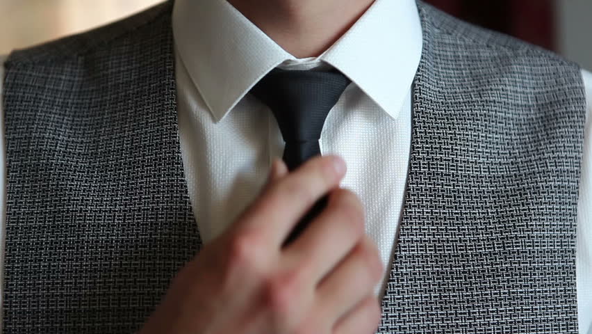 An elegant young man straightens his tie. | Shutterstock HD Video #1098791909