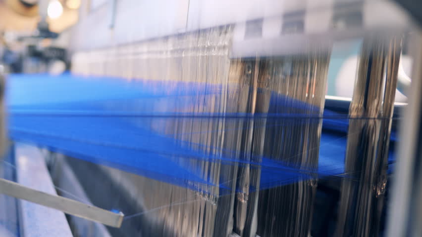 Close up of threads being woven into fabric by a machine Royalty-Free Stock Footage #1098799991