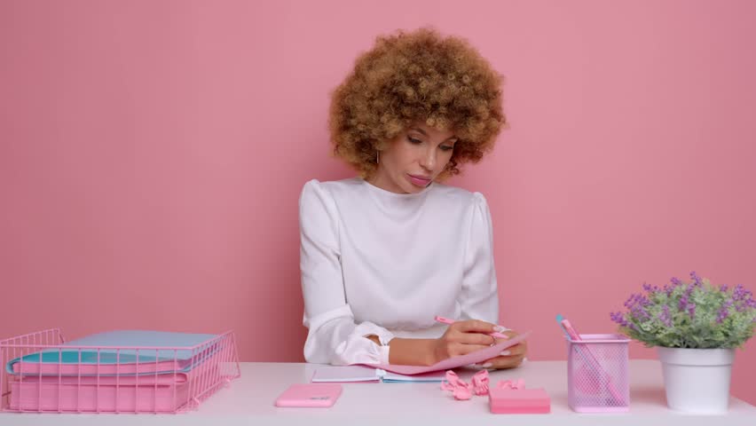 Young business woman losing her patience, works all day at the office, she refuses to work anymore, isolated next to pink wall | Shutterstock HD Video #1098800361