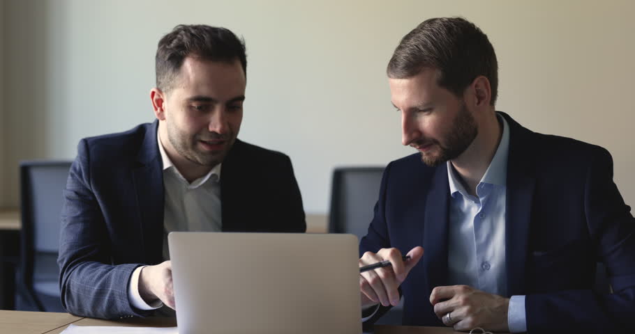 Two colleagues work on project, mentor explain to apprentice corporate software, share ideas about on-line presentation, engaged in teamwork using laptop. Cooperation, manager sell services to client | Shutterstock HD Video #1098801645