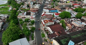 Aerial Drone fly view of moto taxi tuk tuk tuks and heavy traffic close to Belen market in Iquitos, Peru, South America. 4k High resolution video