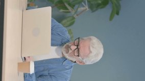 Vertical Video of Coughing Sick Senior Old Man Working on Laptop