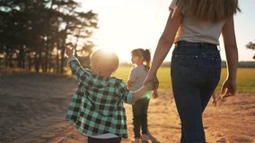 Happy kids holding hands walking.Family of kid active lifestyle in nature at sunset.Group of children are walking in meadow in forest.Funny children dream of parents.Healthy lifestyle walking outdoors - Powered by Shutterstock - Get 15% off with code: PIKWIZARD15