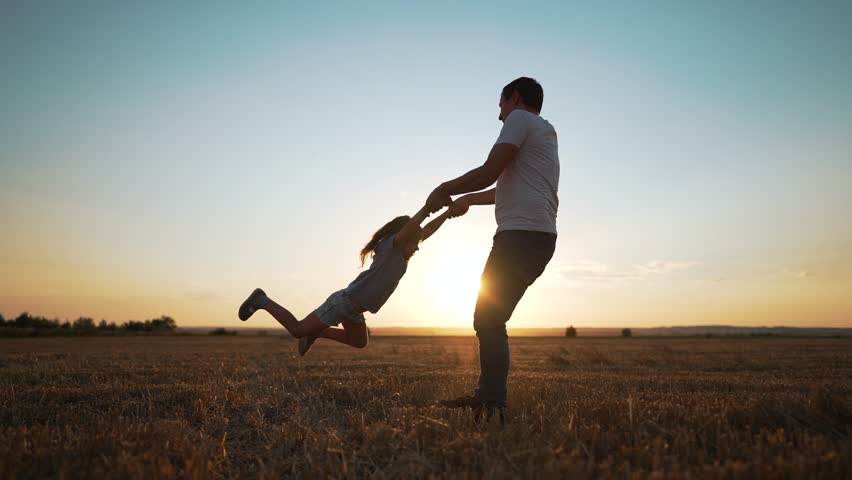 Happy family together in summer on nature.Father spins his daughter by hand in park at sunset.Family picnic on grass.Girl play with her father on grass in nature.Family picnic summer outdoors in park | Shutterstock HD Video #1098814683