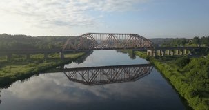 4K high quality summer day aerial drone video of Moscow River channel metal arched railway bridge near town Dubna 70 km north of Moscow, Russia