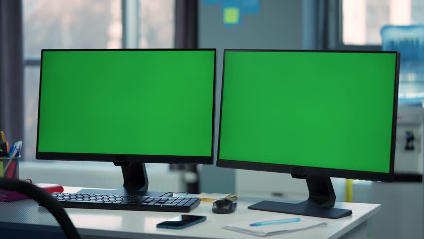 Two Computer Monitors with Mock Up Green Screen Display Standing on Desk in Office | Shutterstock HD Video #1098818457