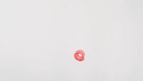 Various color kiss marks on white paper stop motion animation background