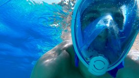 Selfie view of a young man snorkeling with a mask in the mediterranean sea. 