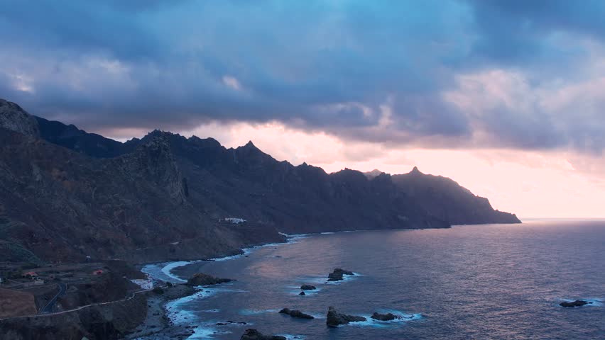 Aerial sunset view of dramatic Atlantic Ocean coastline of Anaga, steep cliffs and small villages, Canary Islands, Spain | Shutterstock HD Video #1098821395