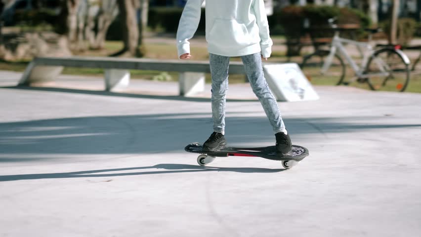 Legs on waveboard close up, Girl riding on casterboard with two wheels, modern street skate sports of teenagers, ripstick for balance ride. | Shutterstock HD Video #1098823053