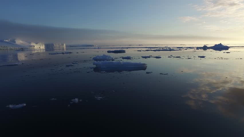Icebergs floating on arctic ocean, Ilulissat, Greenland at sunset | Shutterstock HD Video #1098825985