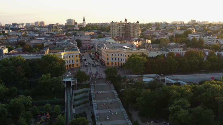 View from drone of evening Odessa city scape. Odessa Potemkin stairs. Building and trees.