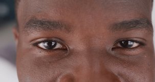 Video close up portrait of the eyes of african american man smiling. Happiness and health concept.