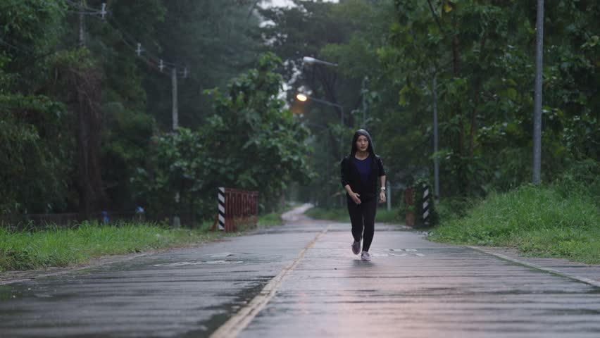 Asian ladies running in the rain	
