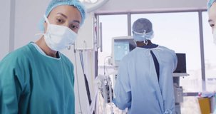Video of three diverse female surgeons talking during operation in theatre, copy space. Hospital, medical and healthcare services.