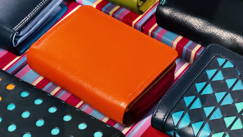 Leather wallets are on the showcase of an accessories store. Closeup