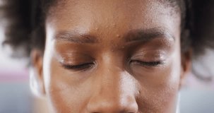 Close up video portrait of blinking eyes of happy african american woman smiling to camera. Happiness and healthy lifestyle.