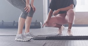 Video of diverse female fitness trainer and woman talking after working out at a gym. Exercise, fitness and healthy lifestyle.