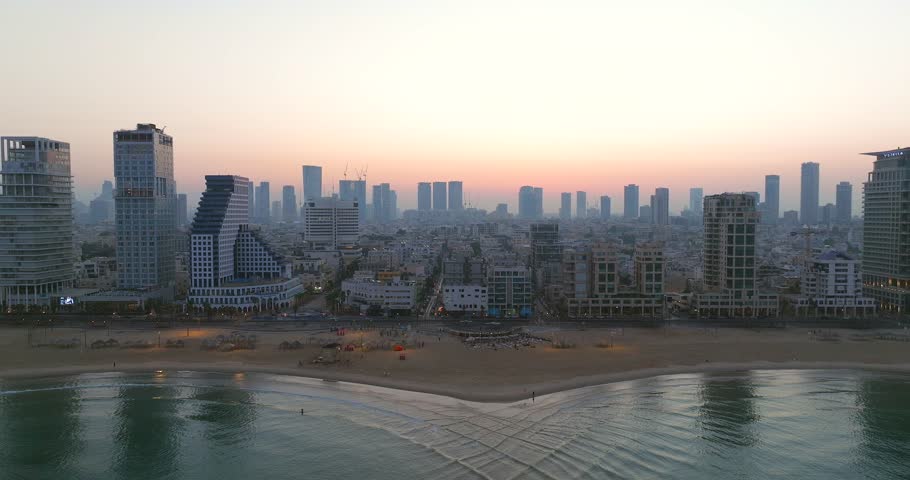 Fly over Tel Aviv coastline at sunrise with beautiful calm waters of The Mediterranean Sea