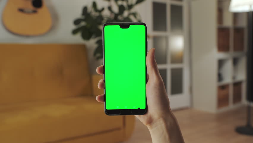 Chroma Key Surfing Internet. Handheld Camera: Point of View of Woman at Modern Room Using Phone With Green Mock-up Screen.Watching Content, Videos Blogs, Tapping on Screen | Shutterstock HD Video #1098843441