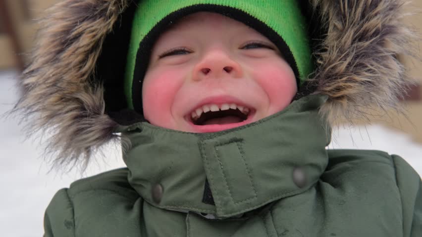Happy Kid Having Fun on Carousel. Front View of Smiling Little Boy Enjoying an Merry-go-round Attraction. Amusement Kiddie Ride. POV. Carefree Young Child Spinning at Playground Carrousel Closeup Face