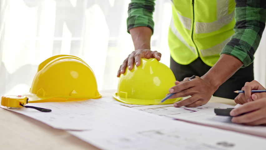 Close up of hands working brainstorming and measuring for cost estimating on paperworks and floor plan drawings about design architectural and engineering for houses and buildings. Royalty-Free Stock Footage #1098844213