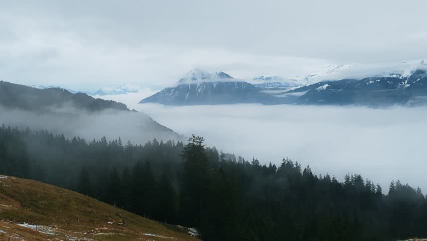 Foggy valleys and the Swiss Alpine peaks near Lucerne, Switzerland