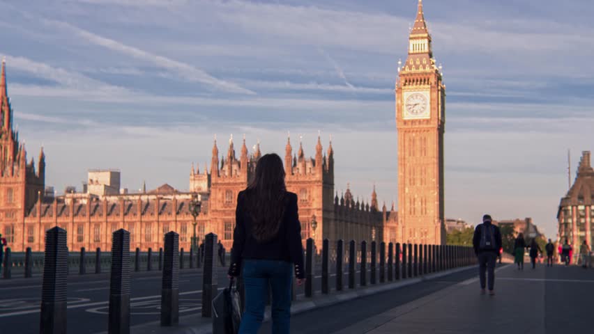 Attractive European looking woman walking on Westminster Bridge London. Stylish trendy business woman having a walk on Westminster Bridge on a morning crowded day Royalty-Free Stock Footage #1098850991