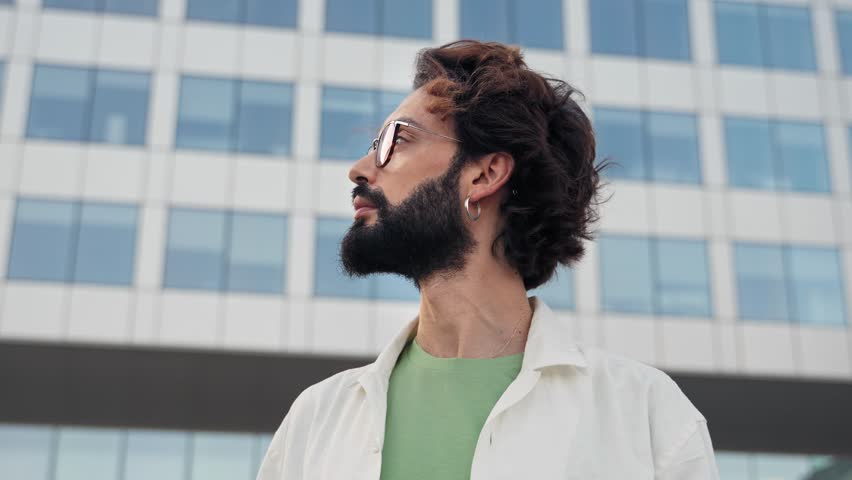 Portrait of young confident hispanic man with eyeglasses and beard in the city | Shutterstock HD Video #1098854557