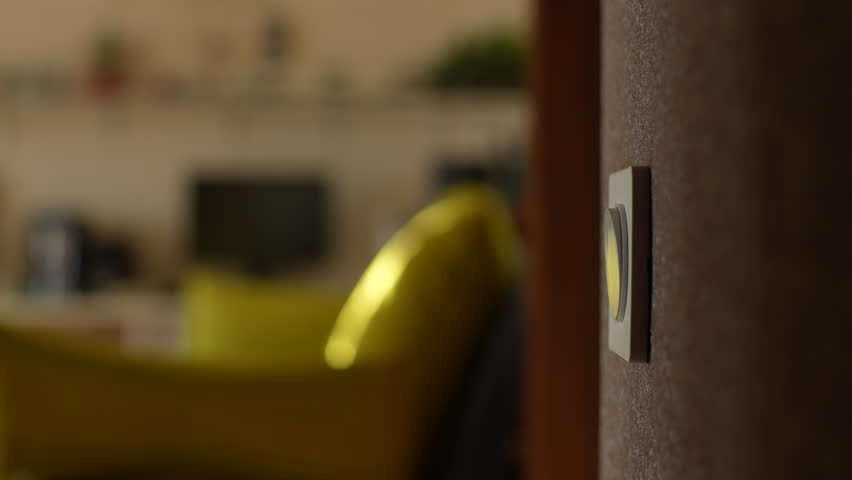 Close-up hands of unrecognizable young man turning light on and off by pushing switch on wall in dark bathroom, view of bright living room. Concept of home comfort. Shooting in slow motion. | Shutterstock HD Video #1098854609