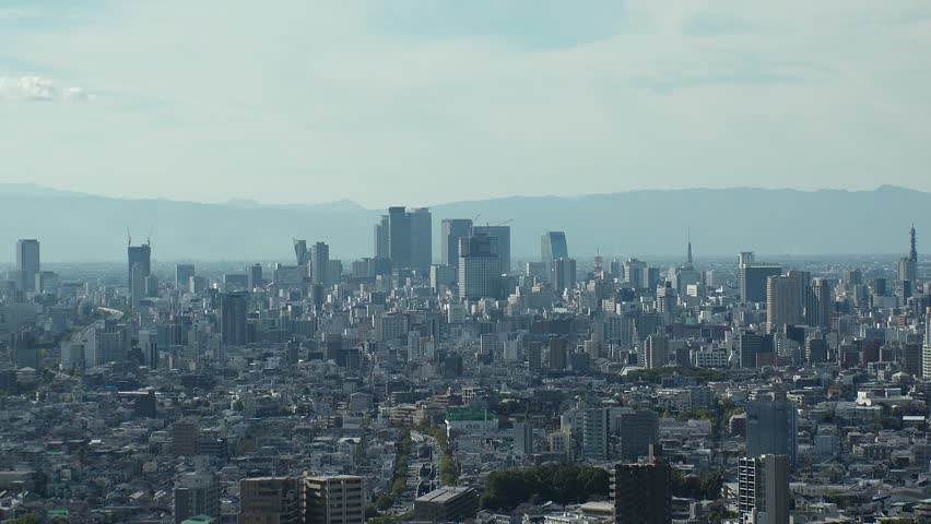 NAGOYA, JAPAN - OCTOBER 2022 : Time lapse shot of NAGOYA CITY in sunny daytime. Aerial high angle view of buildings and street traffic around Nagoya station and Sakae area (central downtown).