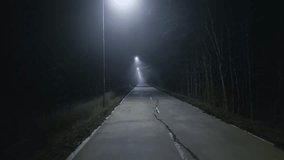 A trip on a rural forest road in a fog at night, flying drone video